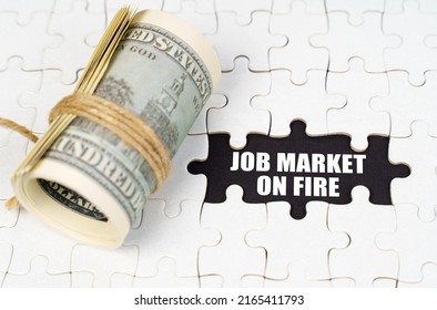 Business Concept. Dollars Lie On White Puzzles, On A Black Surface There Is An Inscription - Job Market On Fire