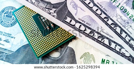 Business concept of the evolution of technology, expressed by a computer chip on a background of dollars