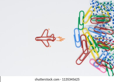 Business concept for group of stacked paperclip with another one red plane paperclip is point to another direction as a team leadership