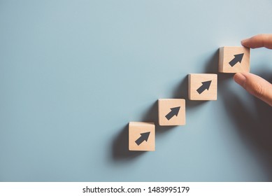 Business concept growth success process, Close up Woman hand arranging wood block stacking as step stair on paper blue background, copy space. - Shutterstock ID 1483995179