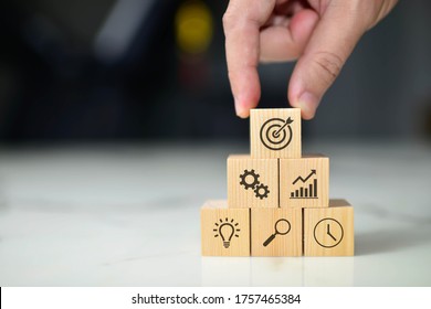 Business concept growth success process, Close up man hand arranging wood block with icon business strategy and Action plan, copy space.