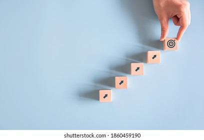 Business concept growth success process, Woman hand arranging wood block stacking as step stair on blue paper background, copy space. - Shutterstock ID 1860459190