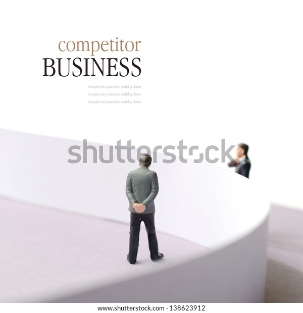 Business concept image\
depicting a competitor situation. Two businessmen divided by a\
wall. Copy space.