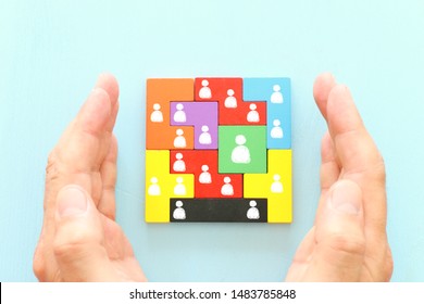 Business Concept Image Of Tangram Puzzle Blocks With People Icons Over Wooden Table ,human Resources And Management Concept