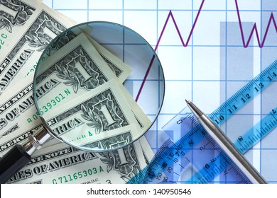 Business concept. Magnifying glass and money on paper background with chart