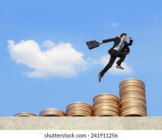 business concept - business man run and jump on money stairs with blue sky background, asian male - Powered by Shutterstock