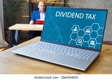 Business Concept Meaning DIVIDEND TAX With Sign On The Screen. 
