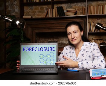 Business Concept Meaning FORECLOSURE With Inscription On The Laptop. Lender Attempts To Recover The Amount Owed On A Defaulted Loan By Taking Ownership Of And Selling The Mortgaged Property
