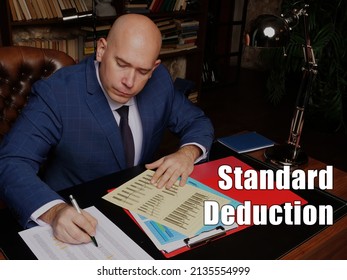 Business Concept Meaning Standard Deduction Businessman, Executive Manager Hand Filling Paper Business Document
