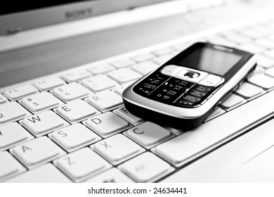 Business concept - mobile phone over laptop keyboard - Shutterstock ID 24634441