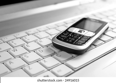 Business concept - mobile phone over laptop keyboard - Shutterstock ID 24916015