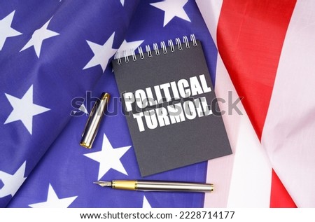 Business concept. On the American flag lies a pen and a notebook with the inscription - political turmoil