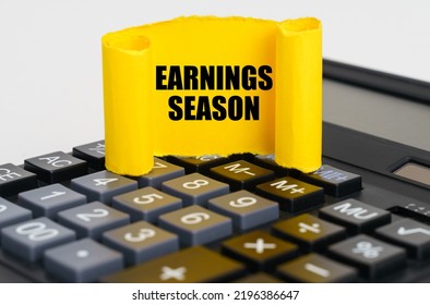 Business Concept. On The Calculator Is A Yellow, Twisted Paper Plate With The Inscription - Earnings Season