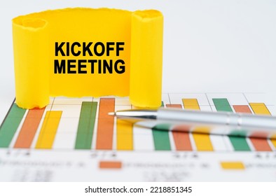 Business Concept. On The Business Charts Are A Pen And A Paper Plate With The Inscription - Kickoff Meeting