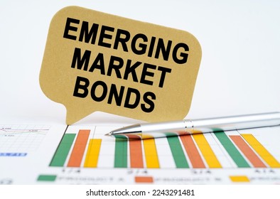 Business concept. On the financial charts lies a pen and a sign with the inscription - emerging market bonds - Shutterstock ID 2243291481
