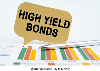 Business concept. On the financial charts lies a pen and a sign with the inscription - high yield bonds - Shutterstock ID 2244417099