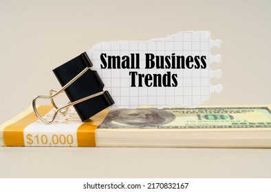 Business Concept. On A Gray Surface Is A Pack Of Dollars On Which There Is A Clip With Torn Paper And The Inscription - Small Business Trends