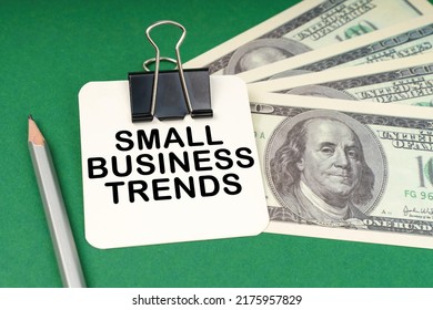 Business Concept. On A Green Surface, A Pen, Dollars And In A Clip Paper With The Inscription - Small Business Trends