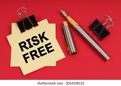 Business Concept. On A Red Background, A Pen And Stickers With The Inscription - Risk Free