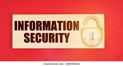 Business Concept. On A Red Background There Is A Small Plaque On It With A Lock And An Inscription - Information Security