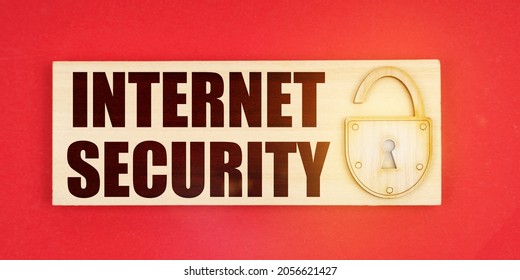 Business Concept. On A Red Background There Is A Small Plaque On It With A Lock And An Inscription - Internet Security