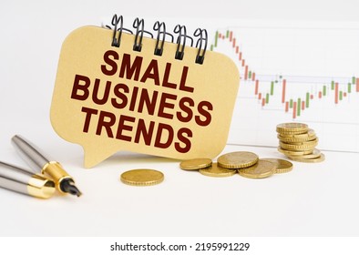 Business Concept. On The Table Are Coins, A Pen, A Graph And A Sign With The Inscription - Small Business Trends