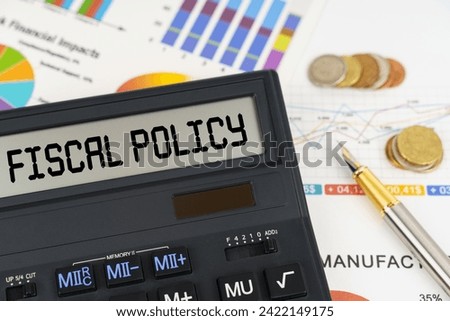 Business concept. On the table are financial reports, coins and a calculator with the inscription - Fiscal policy