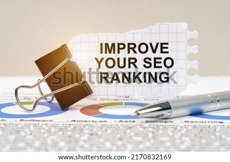 Business concept. On the table are reporting charts, a pen, in a clip paper with the inscription - Improve Your Seo Ranking
