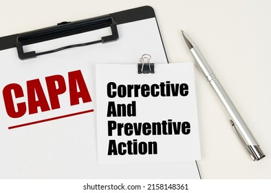 Business concept. On the tablet is a sheet of paper with the inscription - CAPA and stickers with the inscription - Corrective And Preventive Action, next to the pen.