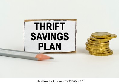 Business Concept. On A White Background, A Pencil, Coins And A Sign With The Inscription - Thrift Savings Plan