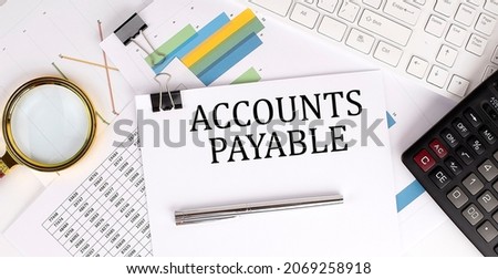 Business concept. Paper with text ACCOUNT PAYABLE , near calculator and charts.
