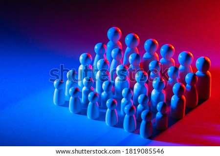 Business concept. Personnel selection. Bounty hunting. Lots of staff. The concept of the labour market. Wooden men on a bright background.
