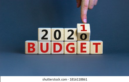 Business concept of planning 2021. Male hand flips wooden cube and change the inscription 'BUDGET 2020' to 'BUDGET 2021'. Beautiful grey background, copy space. - Shutterstock ID 1816118861