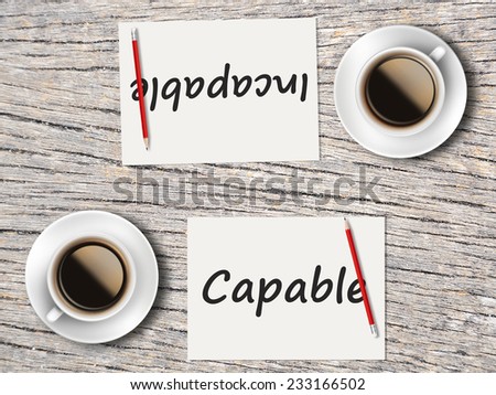 Business Concept (Rotatable) : Two Coffee, Papers And Pencils On The Table  Facing Each Other Head To Head To Compare Between Capable And Incapable.