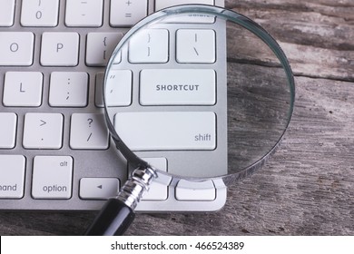 Business Concept: SHORTCUT On Computer Keyboard On Wooden Background With Copyspace Area.