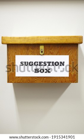 Business Concept Shot Of Wooden Suggestion Box On Wall In Office