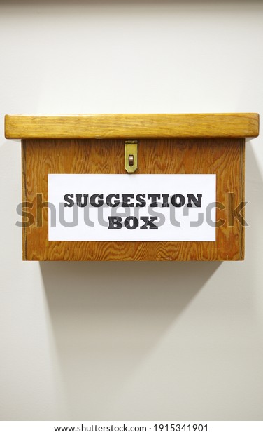 Business Concept Shot Of Wooden Suggestion Box On\
Wall In Office
