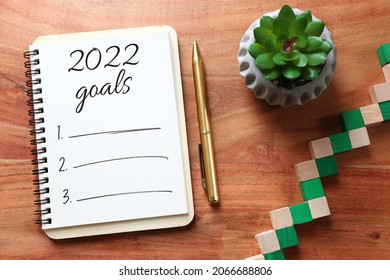 Business Concept Of Top View 2020 Goals List With Notebook Over Wooden Desk