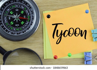 Business concept. Top view of compass, magnifying glass and memo notes written with text Tycoon. Selective focus. - Shutterstock ID 1848659863