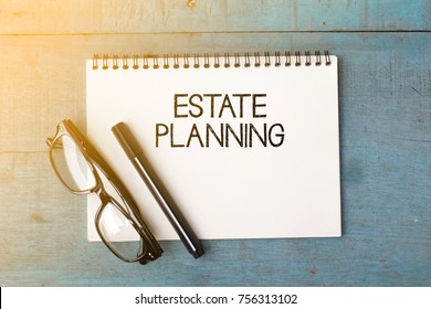 Business concept - Top view notebook writing ESTATE PLANNING