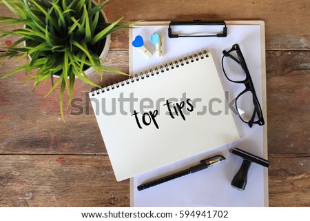 Business concept - Top view notebook writing TOP TIPS