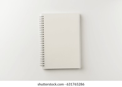 Business Concept - Top View Of Spiral Blank Notebook On White Background Desk For Mockup