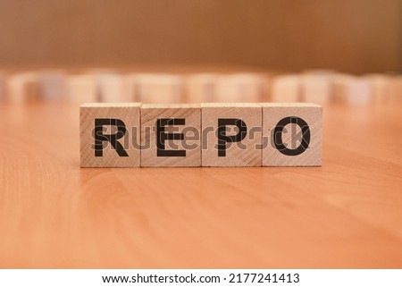 business concept. wooden cubes with the inscription - REPO, brown background. REPO - Repurchase Agreement
