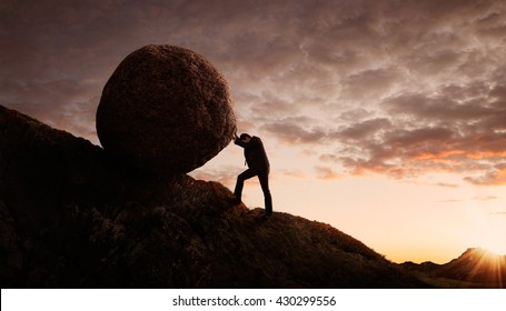 Business concept, Young businessman pushing large stone uphill with copy space