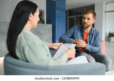 Business concept. Young dark-haired woman sitting in front of mature cheerful office manager on job interview, having relaxing talk about her experience and study degree - Shutterstock ID 2198890999
