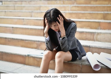 Business Concepts. Businessmen are stressed in the city. Business people are headache and uneasy. The unemployed business woman is crying. - Shutterstock ID 1080995339