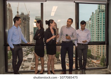 Business Concepts. Young business people is playing mobile. Business people are contacting customers. Businessmen are using a telephone for communication. - Shutterstock ID 1077085475