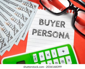 Business concept.Text BUYER PERSONA writing on notepaper with fake money,glasses and calculator on red background.