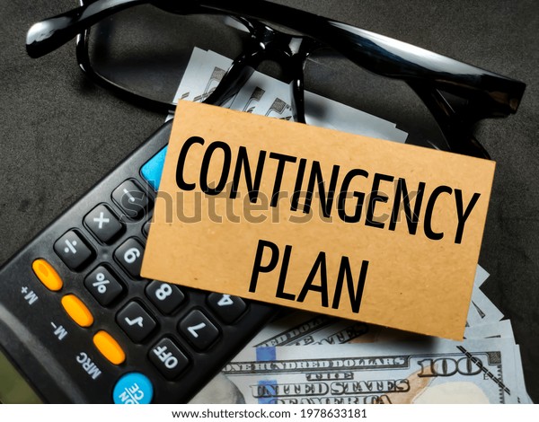 Business concept.Text CONTINGENCY\
PLAN with banknote,calculator and glasses on black\
background.