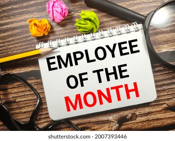 Business concept.Text EMPLOYEE OF THE MONTH on notebook with torn paper,magnifying glass,glasses and pencil on wooden background. - Powered by Shutterstock